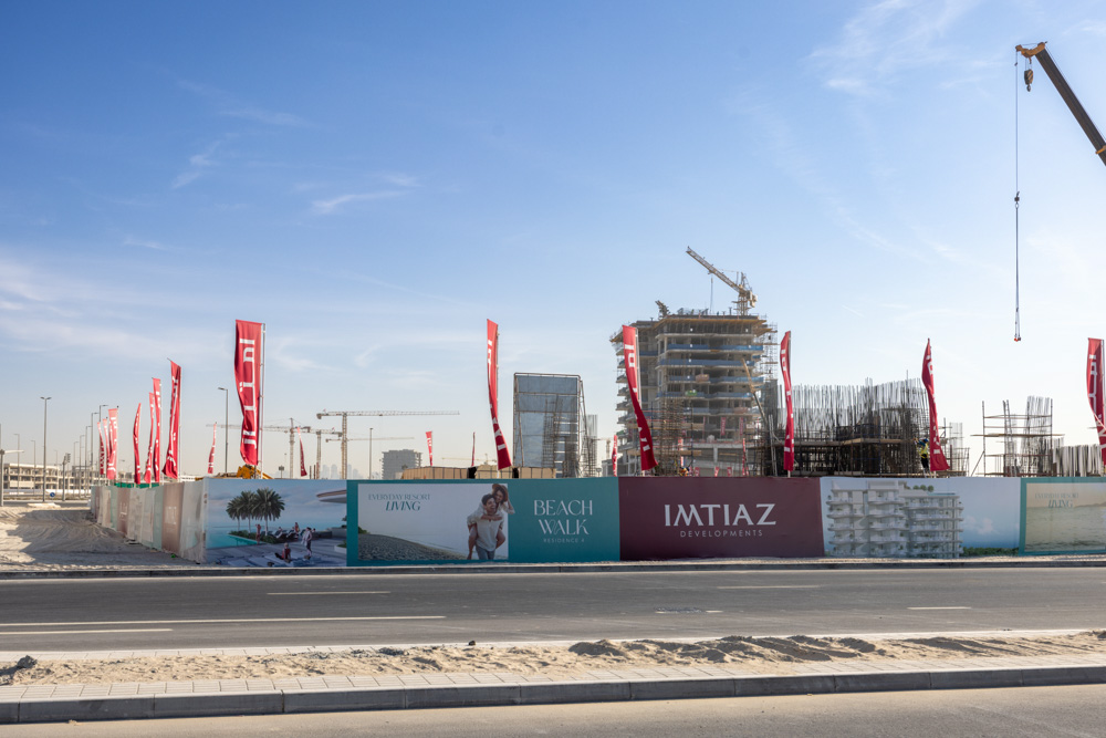 Cotier House 2 By Imtiaz Construction site with cranes and banners for Beach Walk and Imtiaz Developments under a clear blue sky.